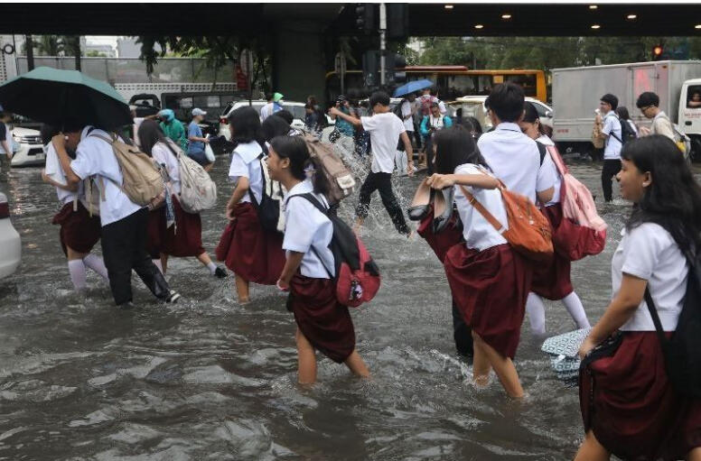 High schoolers walk through the floods at Taft and UN Avenues in Manila Courtesy: The Star | Edd Gumban